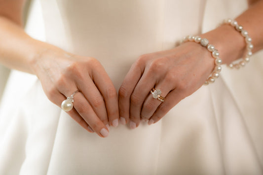Close up of a bride's hands wearing wedding day jewelry. 