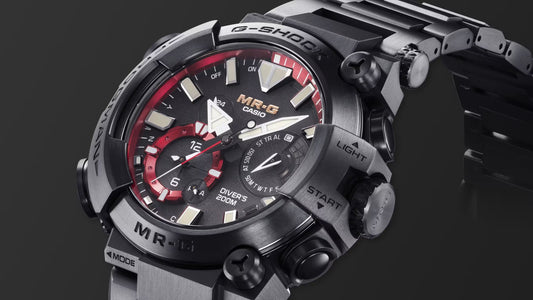 Close-up of the Casio MR-G G-SHOCK Diver’s 200M watch featuring a black titanium case and bracelet, black dial with red accents, luminous markers, and rugged pushers labeled “Light” and “Start.”