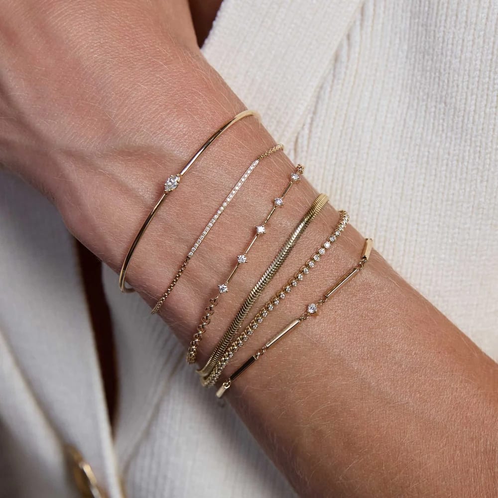 14K GOLD 4 PRONG DASH BRACELET WITH PRONG SET 2MM WHITE DIAMONDS WITH A 6-7" ADJUSTABLE SMALL ROLO CHAIN (.15 CTW)