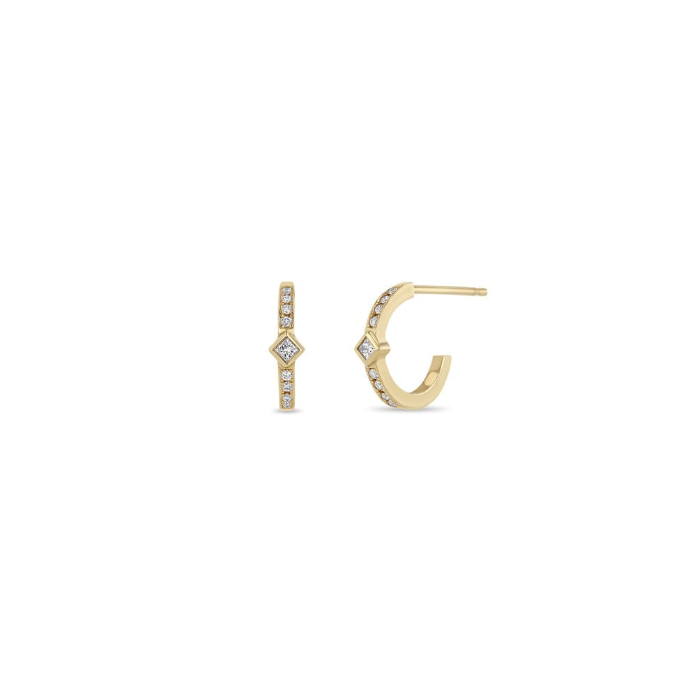 14K GOLD HUGGIE HOOP EARRINGS WITH A BEZEL SET PRINCESS DIAMOND IN THE MIDDLE AND 4 WHITE PAVE DIAMONDS ON EACH SIDE