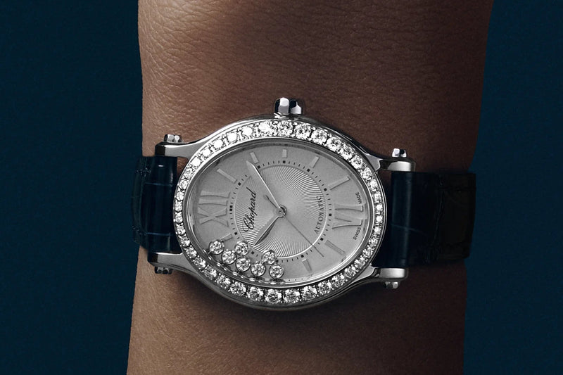 Woman wearing a Chopard watch on a dark background