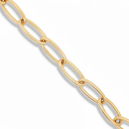 A close-up of a gold chain with elongated oval links, shown diagonally against a clean white background.