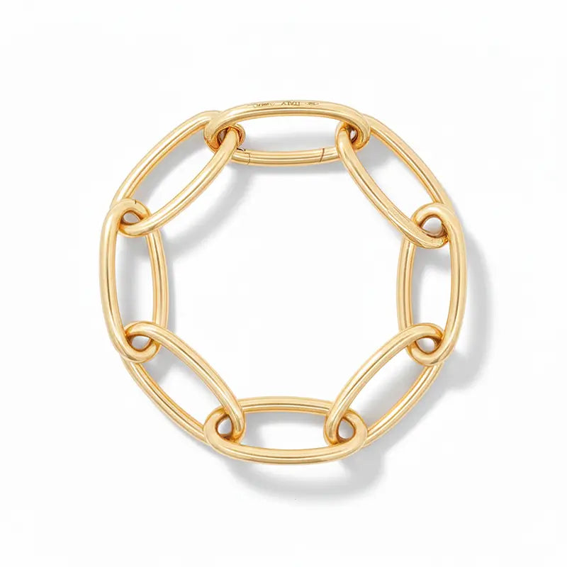Gold chain links forming a bracelet on a white background.