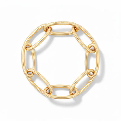 Gold chain links forming a bracelet on a white background.